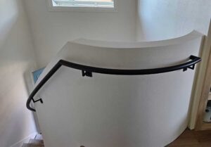 Custom curved stair railing installation in modern architecture