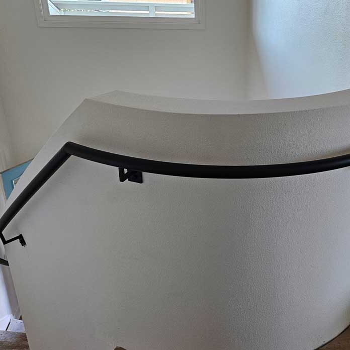 Custom curved stair railing installation in modern architecture